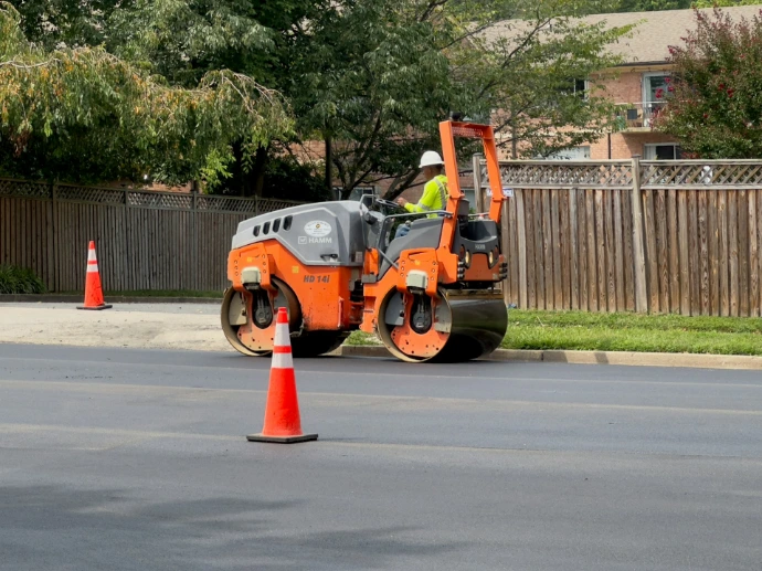 a man on a street working on a road